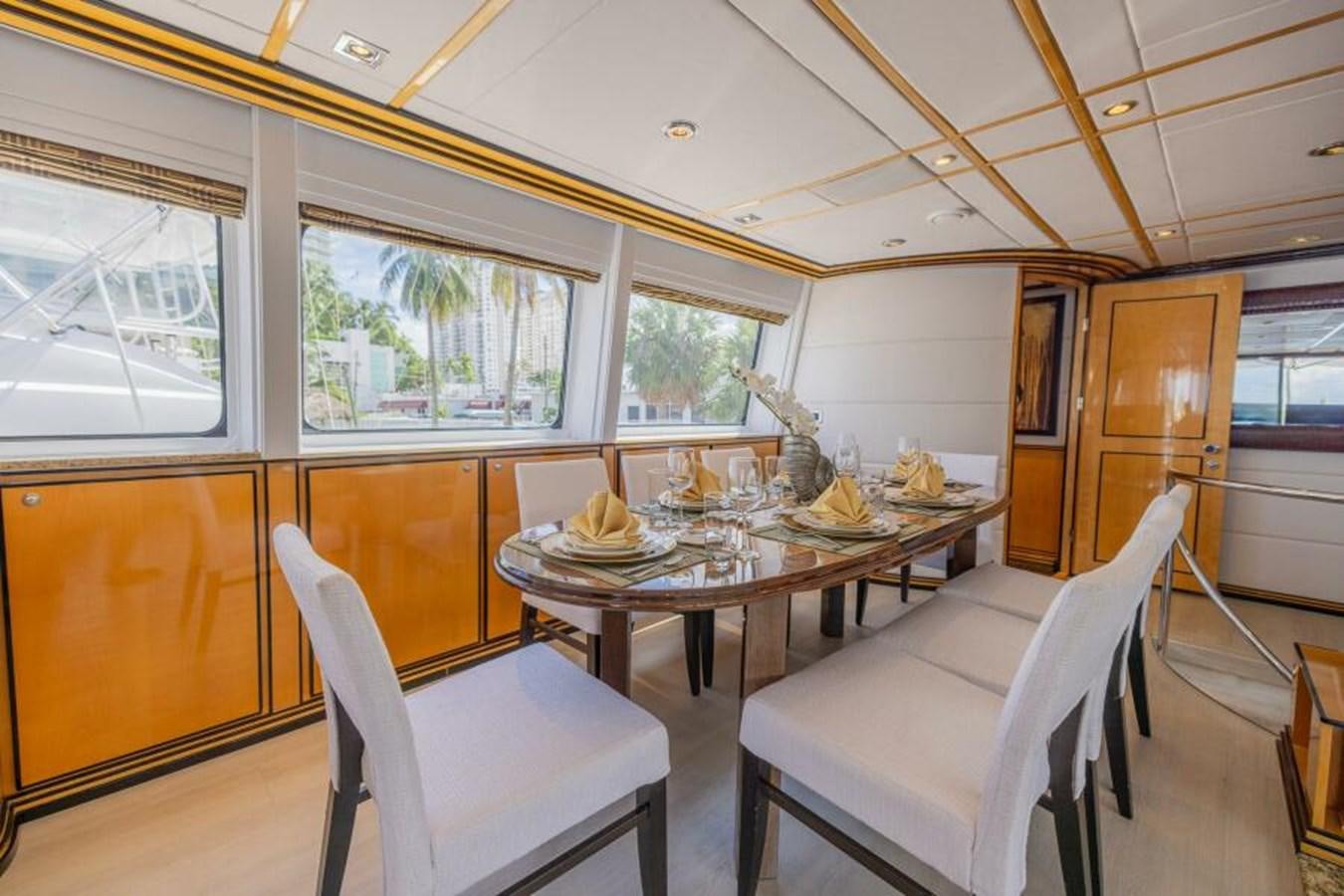 a dining room with a table and chairs aboard ENTOURAGE Yacht for Sale