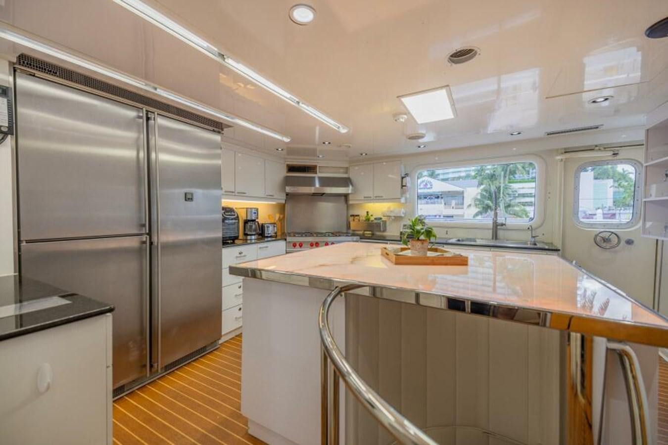 a kitchen with a large refrigerator aboard ENTOURAGE Yacht for Sale