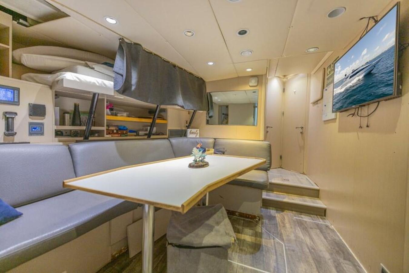 a room with a table and chairs aboard ENTOURAGE Yacht for Sale