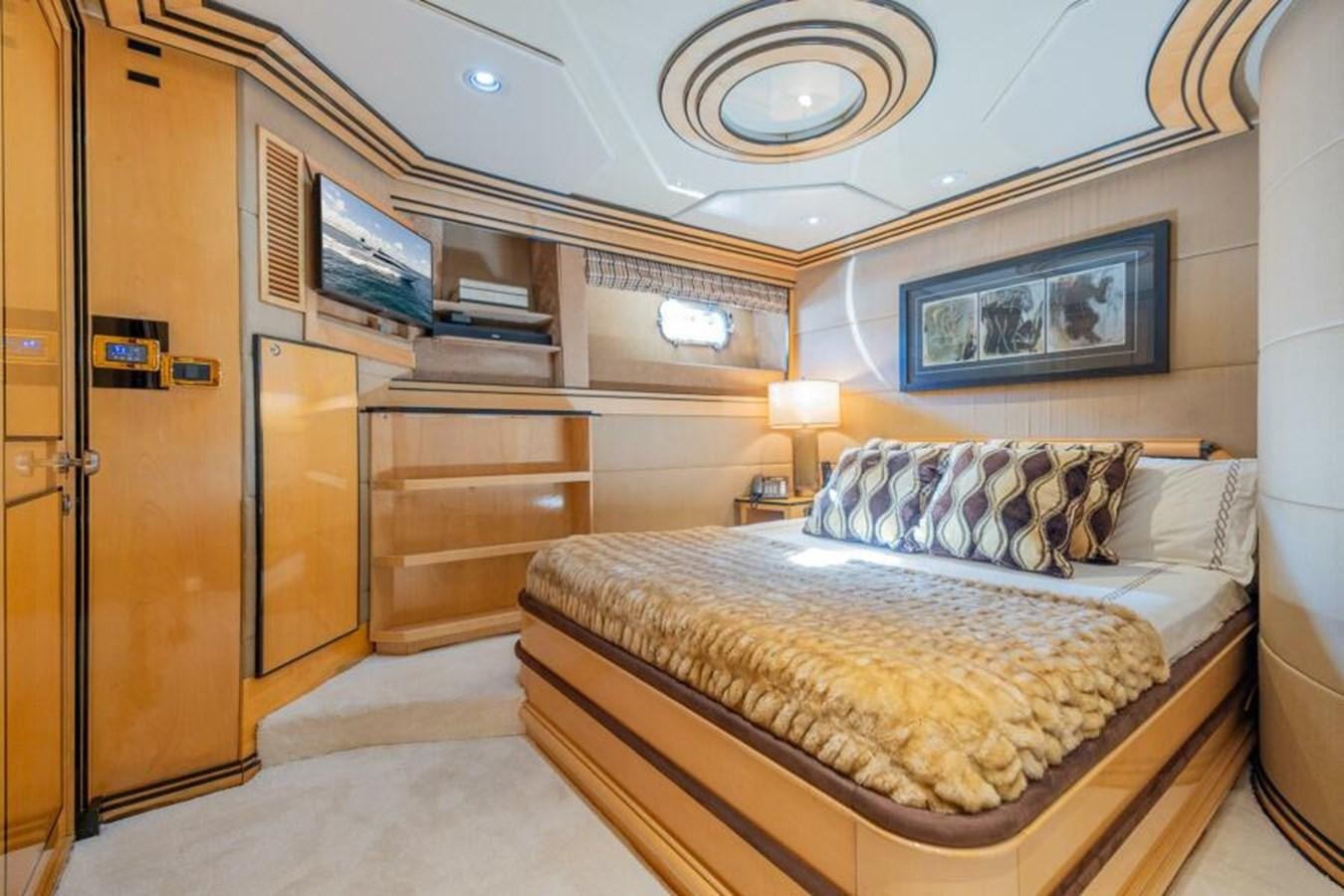 a bedroom with a bed and a tv aboard ENTOURAGE Yacht for Sale