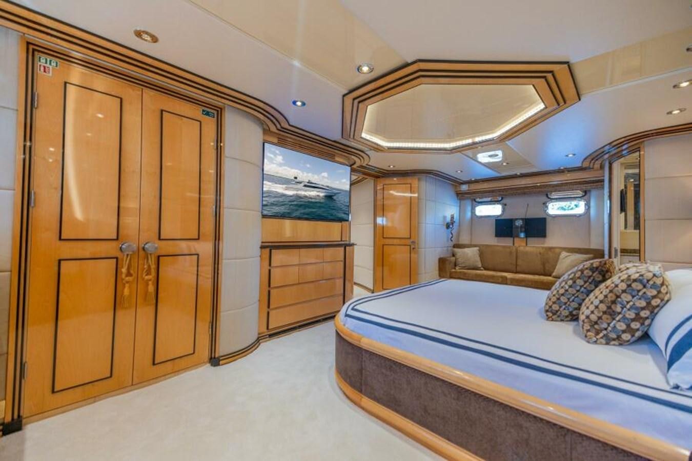 a room with a bed and a door aboard ENTOURAGE Yacht for Sale