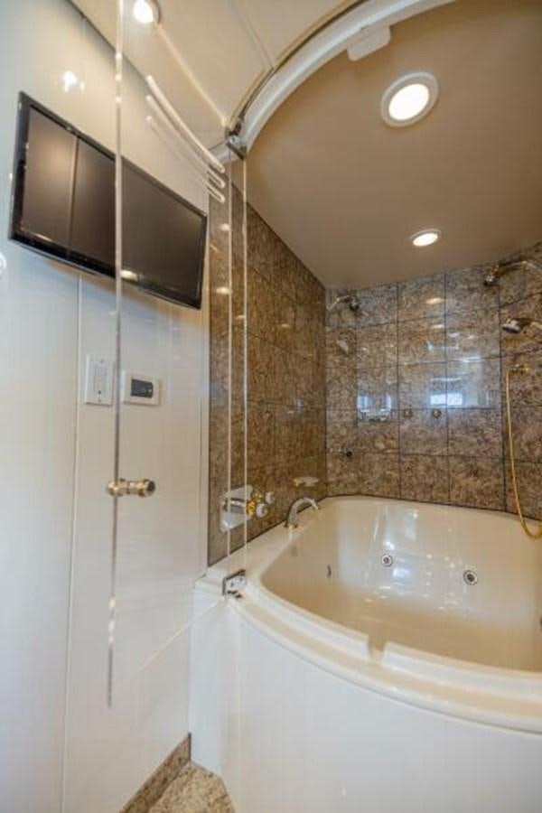 a bathroom with a bathtub and a sink aboard ENTOURAGE Yacht for Sale