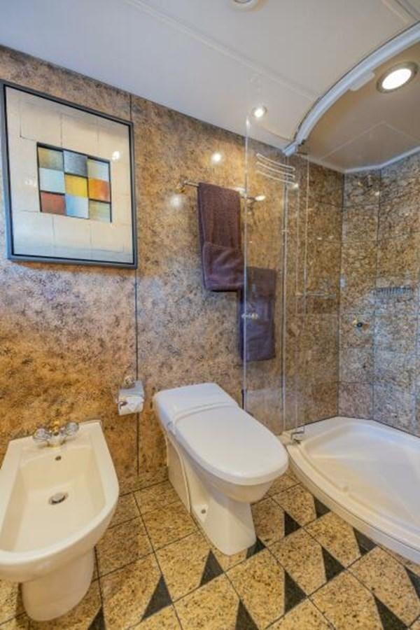 a bathroom with a toilet and a bathtub aboard ENTOURAGE Yacht for Sale