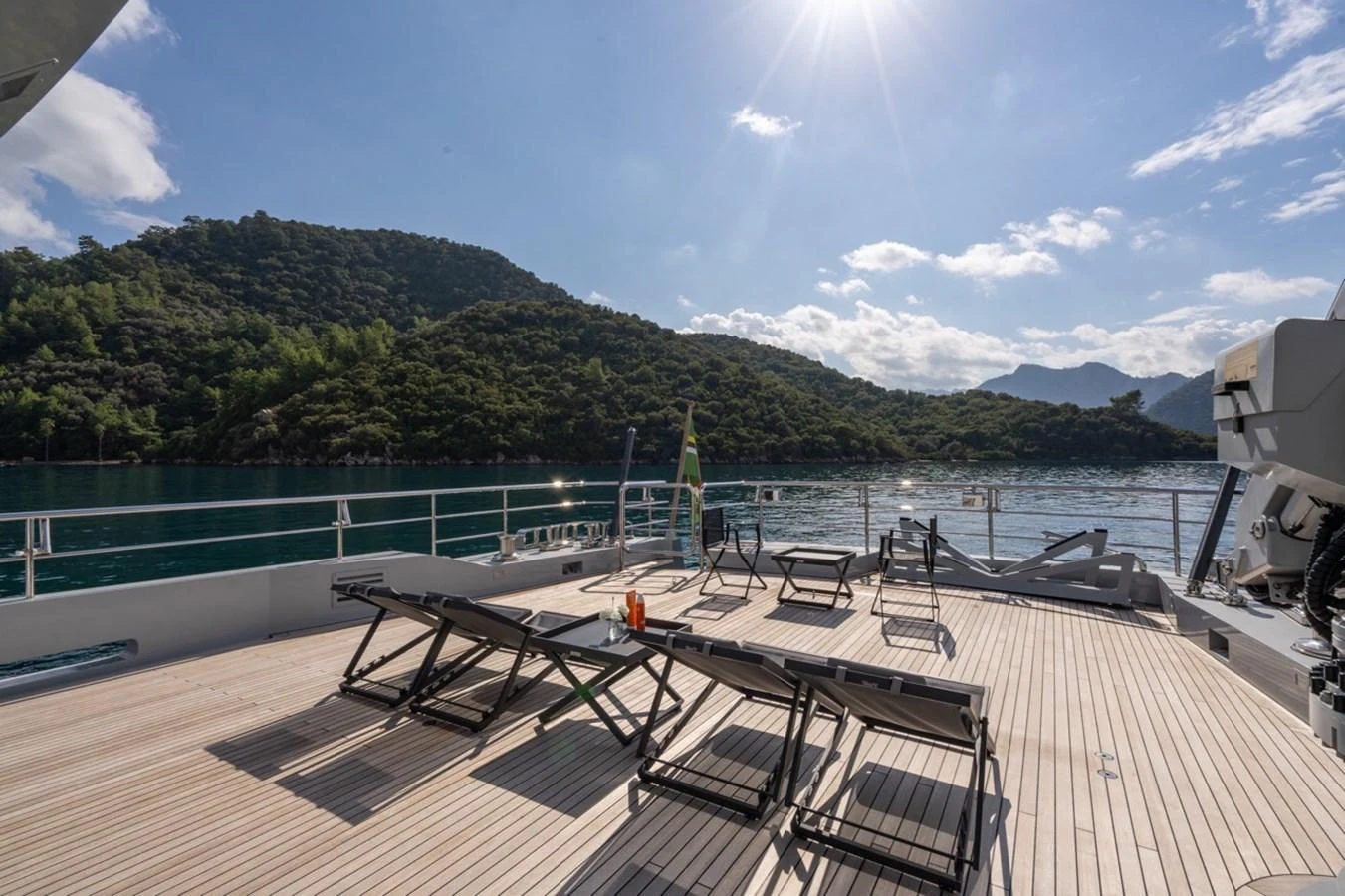 a deck with chairs on it by a body of water aboard K584 Yacht for Sale