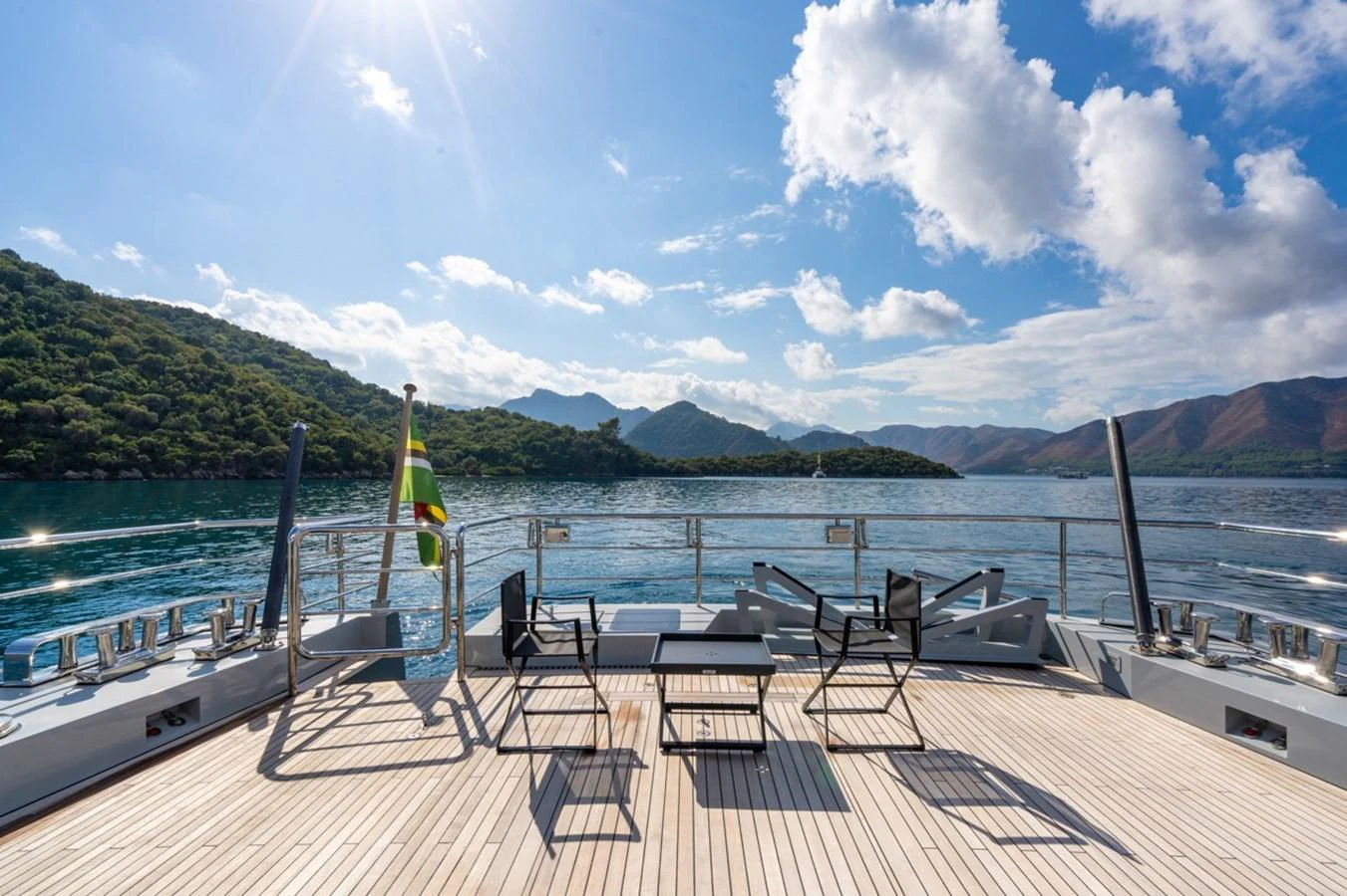 a deck with chairs and a table on it aboard K584 Yacht for Sale