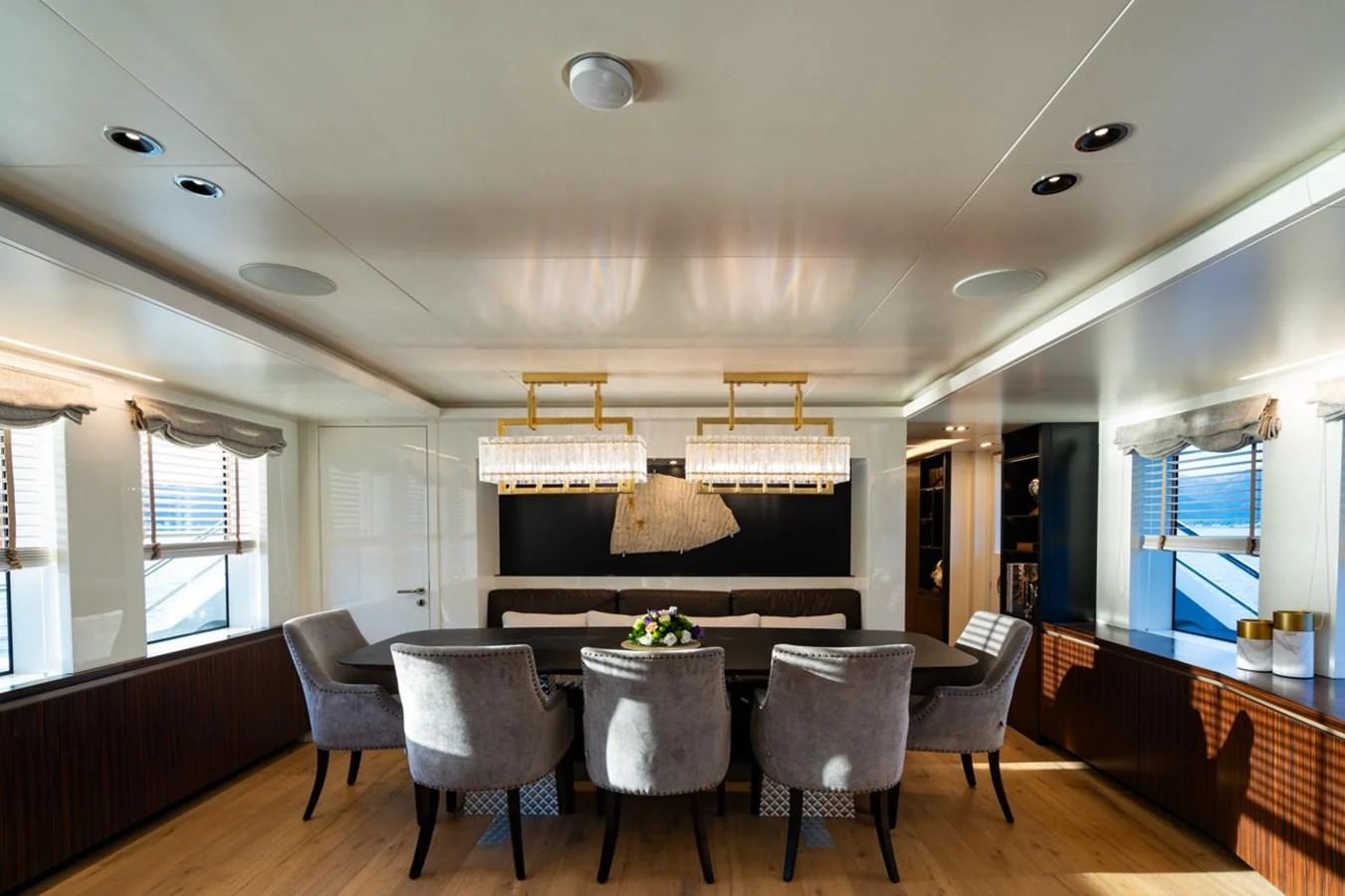 a large dining room with a chandelier aboard K584 Yacht for Sale