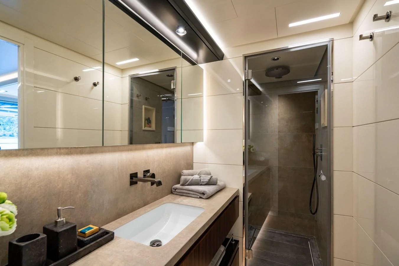 a bathroom with a glass shower aboard K584 Yacht for Sale