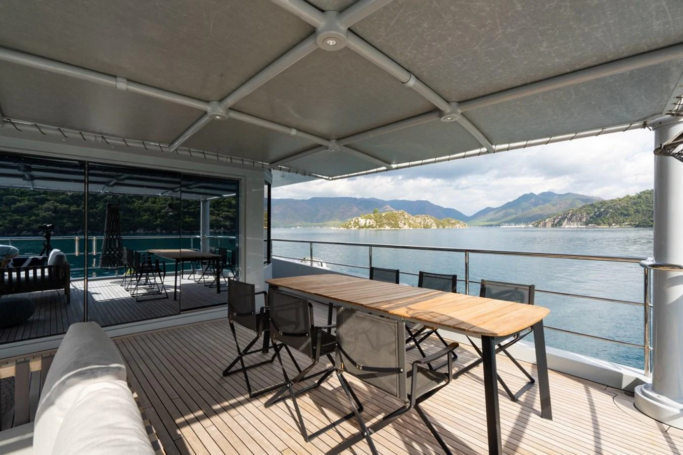 a table and chairs on a deck aboard K584 Yacht for Sale