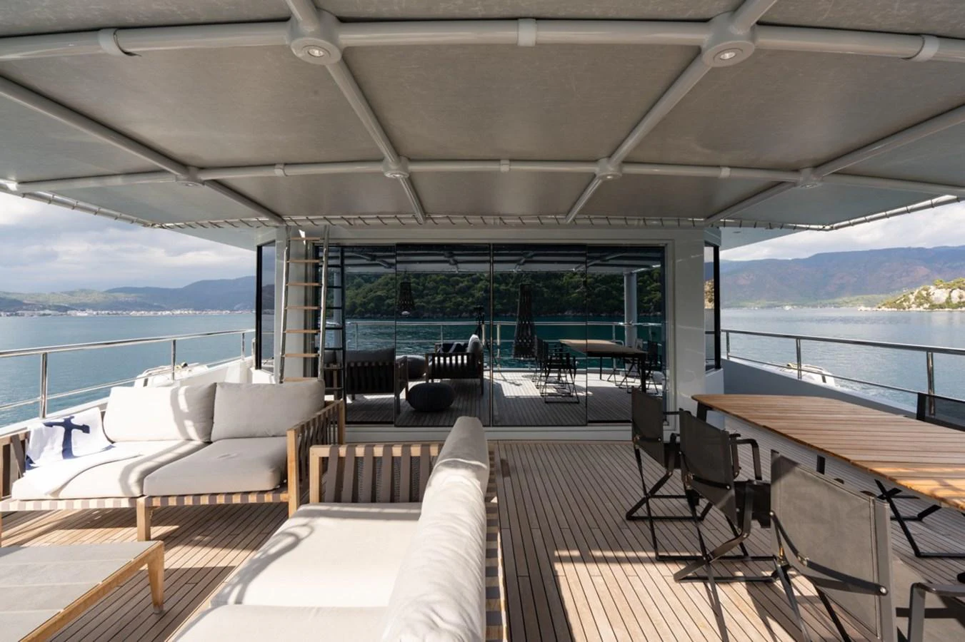a deck with a view of the ocean and the ocean aboard K584 Yacht for Sale