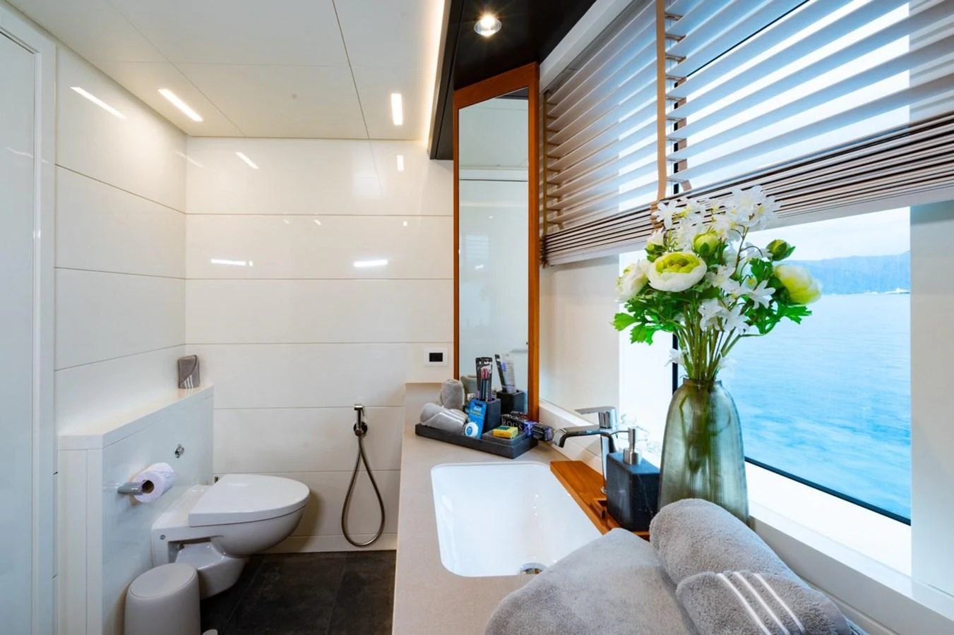 a bathroom with a vase of flowers aboard K584 Yacht for Sale
