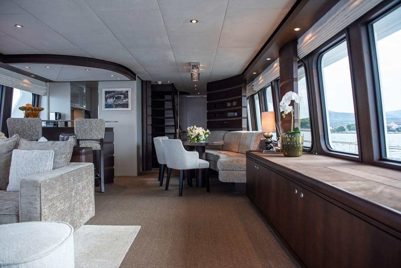 a living room with a large window aboard NASHIRA Yacht for Sale