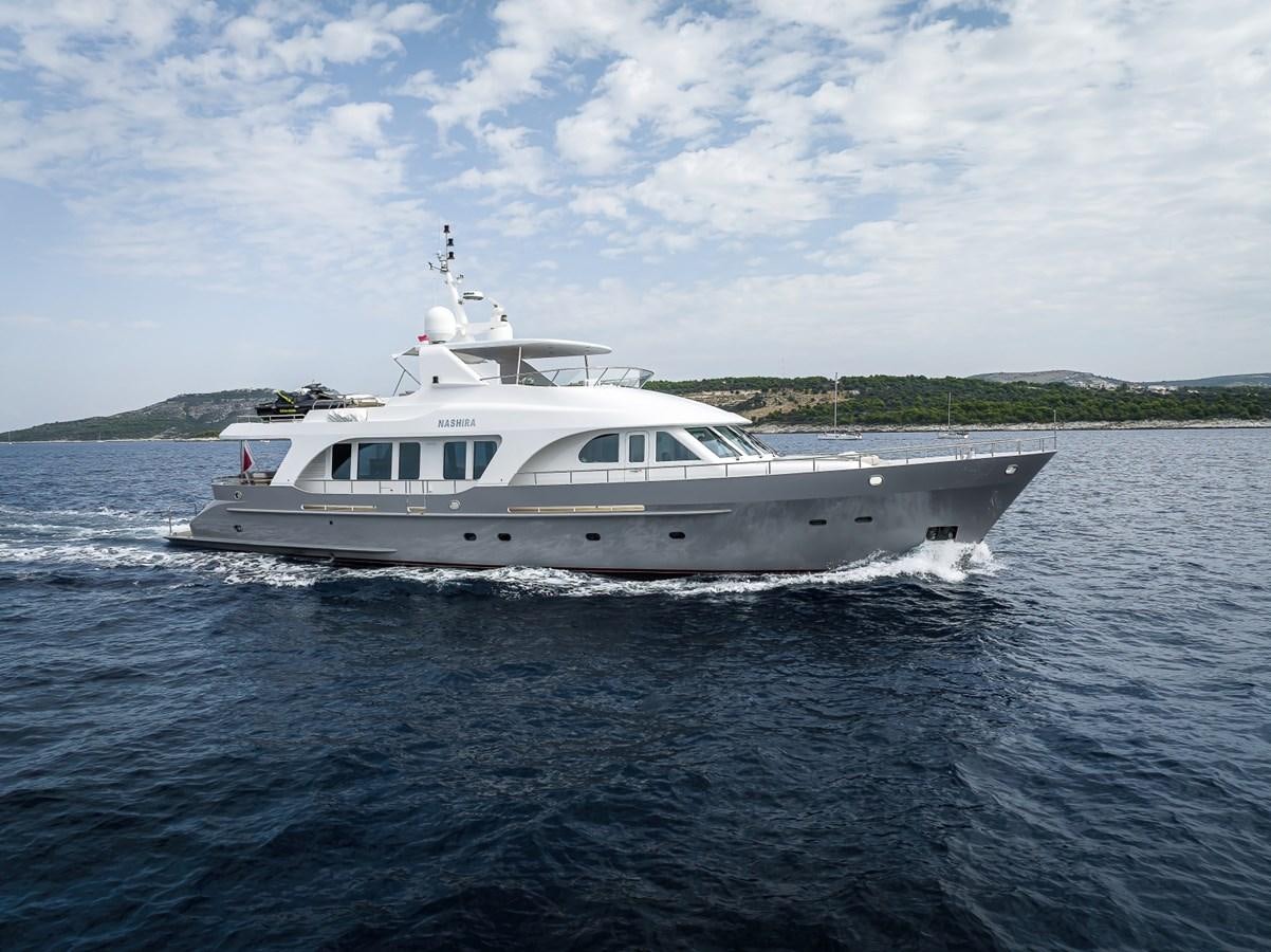 a white boat in the water aboard NASHIRA Yacht for Sale
