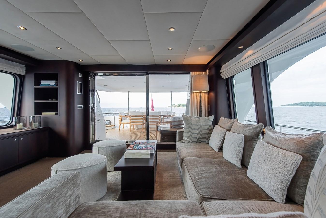 a living room with a large window aboard NASHIRA Yacht for Sale