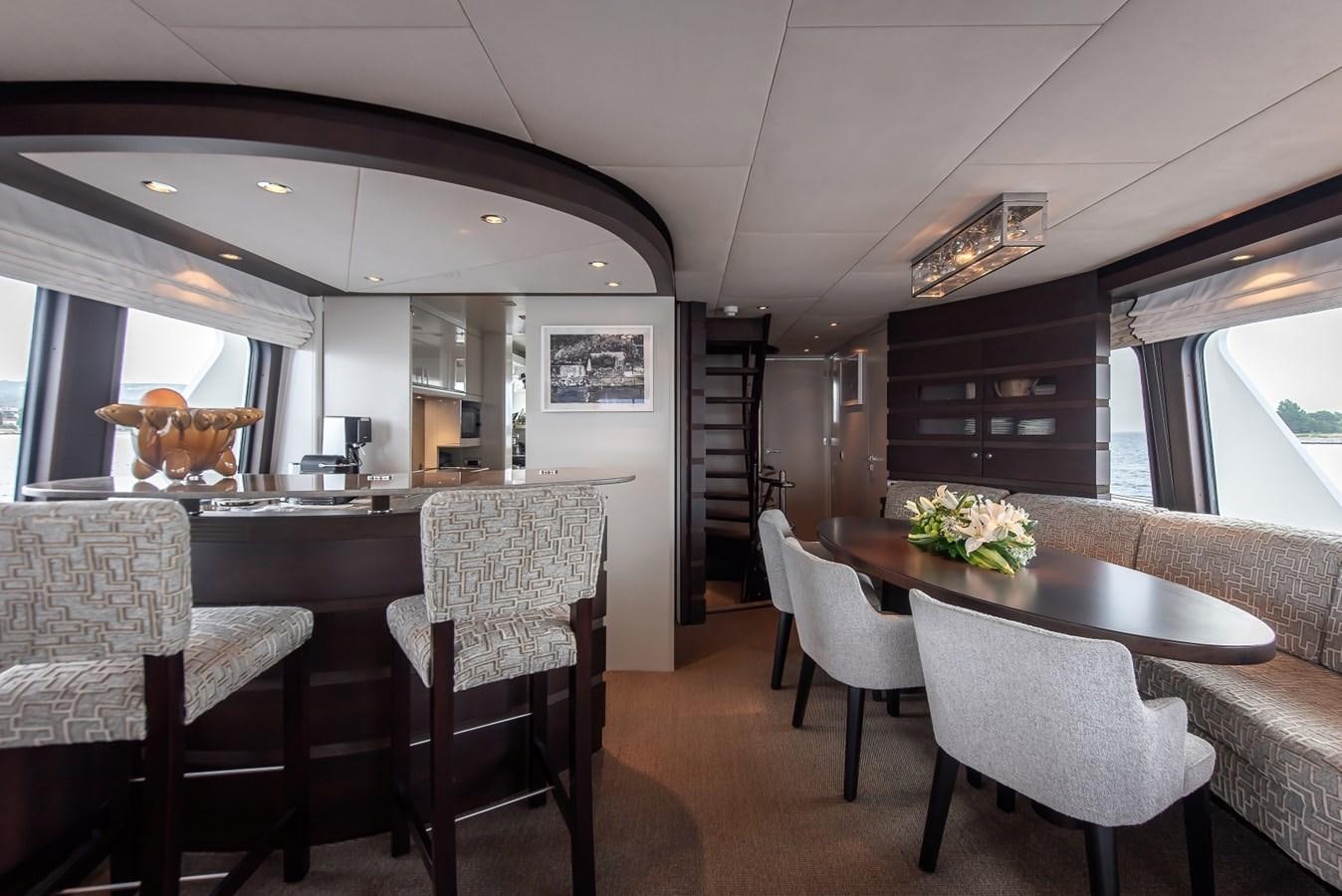 a dining room with a table and chairs aboard NASHIRA Yacht for Sale