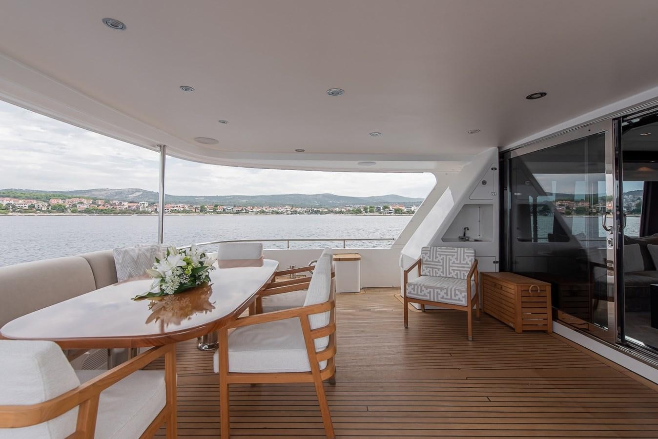 a room with a table and chairs aboard NASHIRA Yacht for Sale