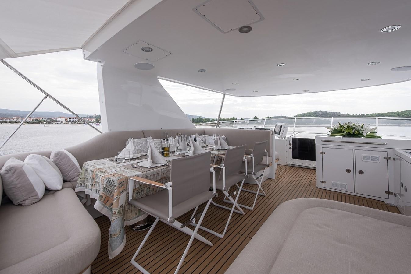 a white tent with a table and chairs aboard NASHIRA Yacht for Sale