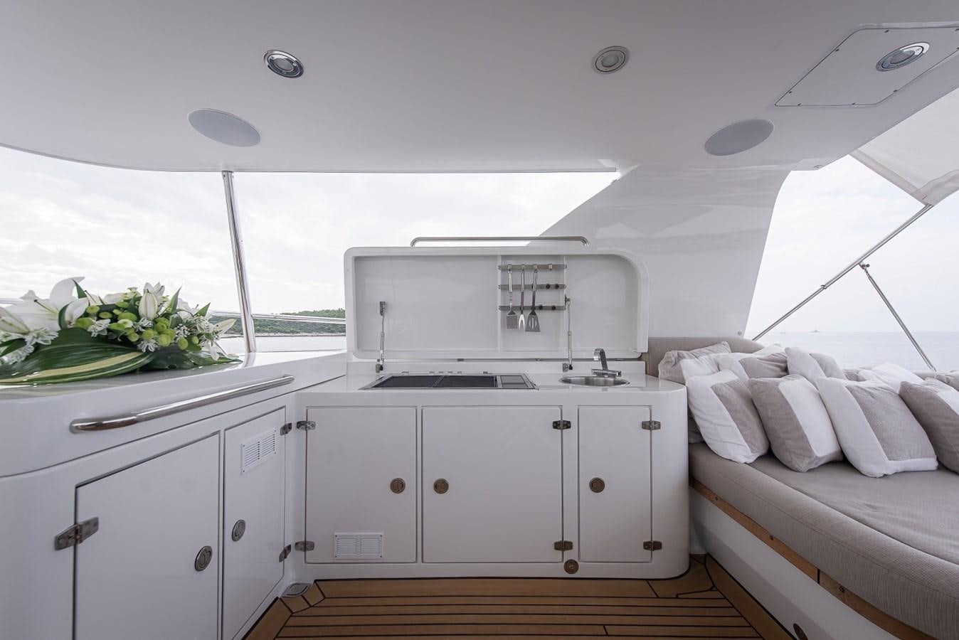 a kitchen with white cabinets aboard NASHIRA Yacht for Sale