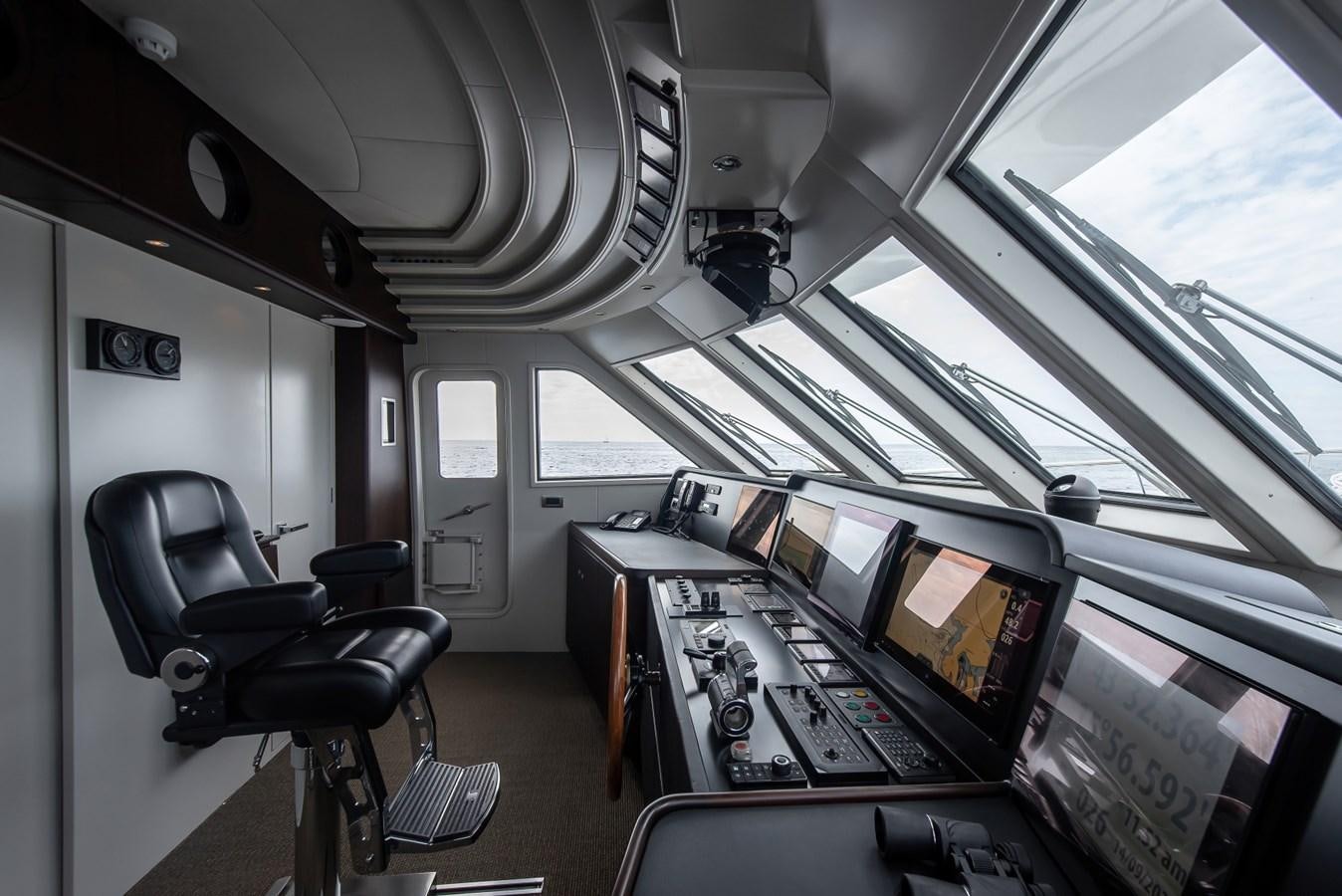 a room with a chair and a desk with computers on it aboard NASHIRA Yacht for Sale