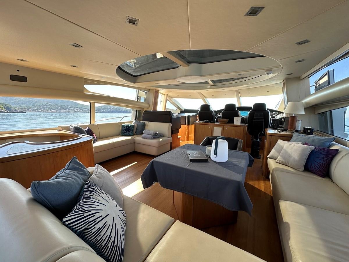 a boat with a table and chairs aboard LOW PROFILE Yacht for Sale