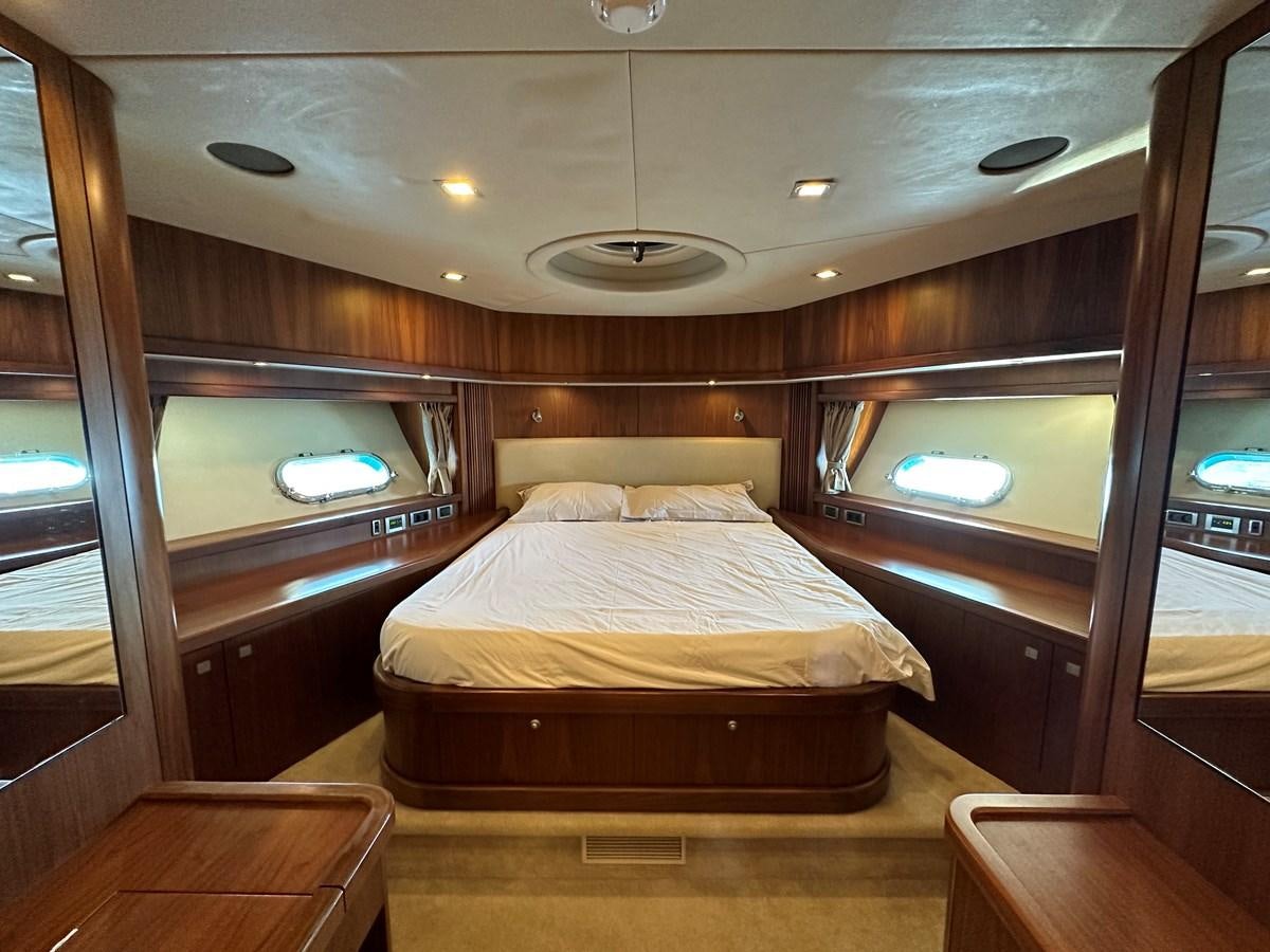 a room with a bed and a window aboard LOW PROFILE Yacht for Sale