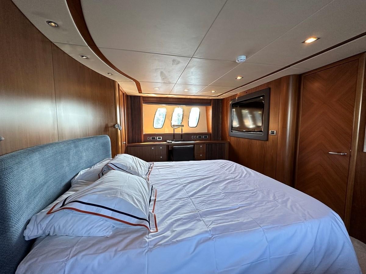 a bed with white sheets aboard LOW PROFILE Yacht for Sale