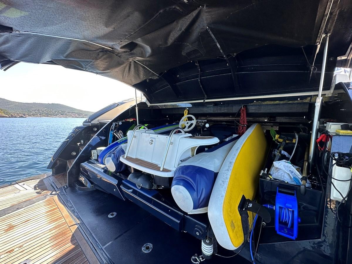 a boat with a yellow surfboard on the deck aboard LOW PROFILE Yacht for Sale