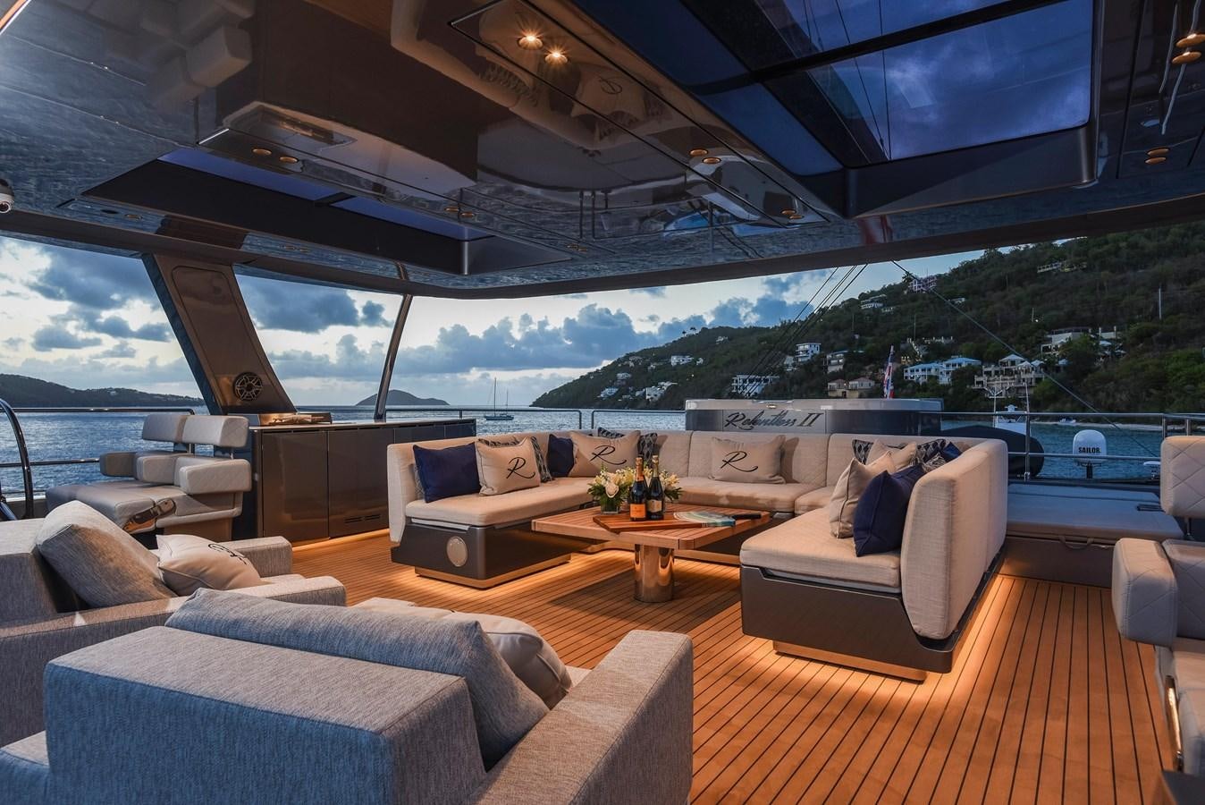 a living room with a large window aboard 2022 SUNREEF 80 SAILING Yacht for Sale