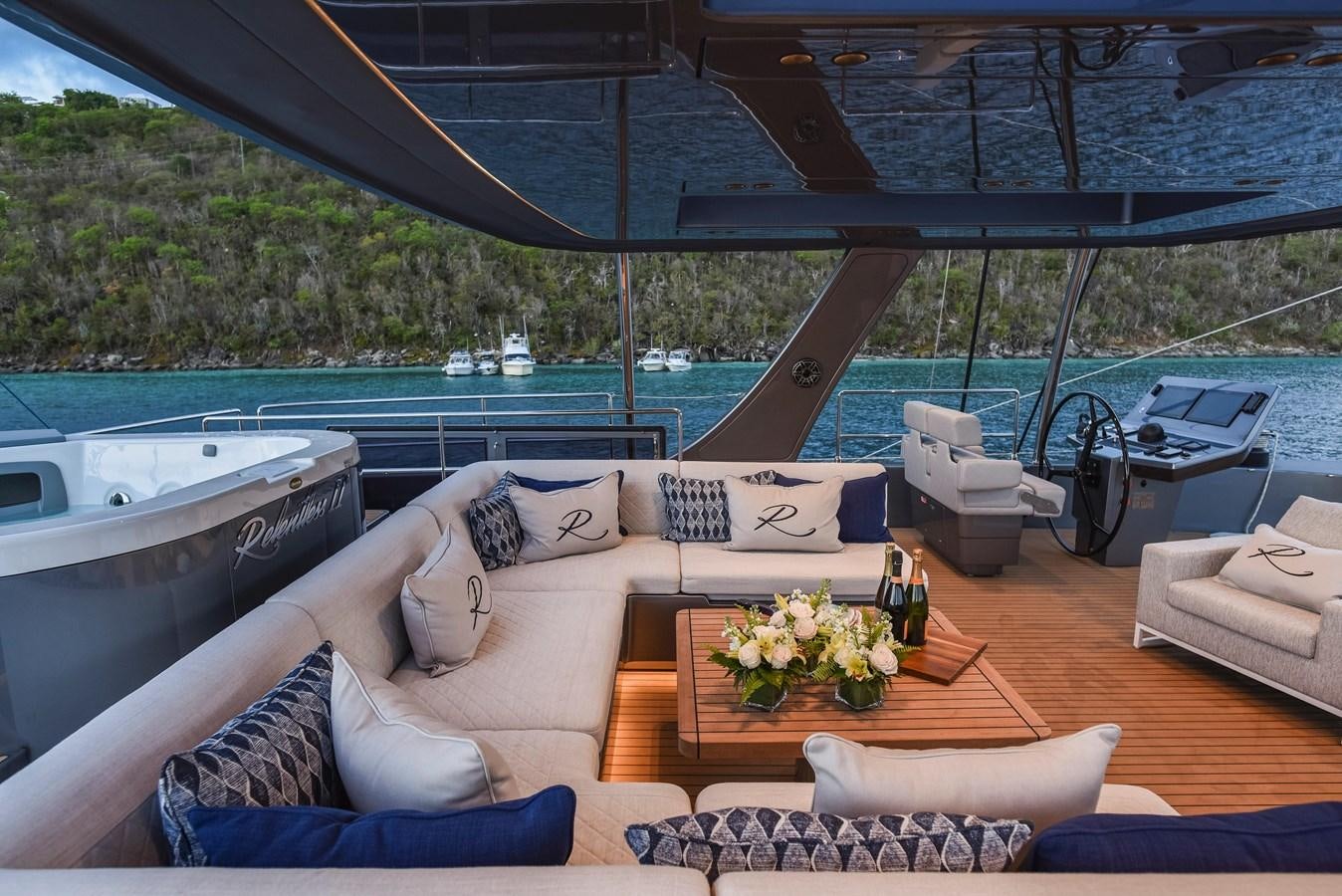 a lounge area with a couch and a pool aboard 2022 SUNREEF 80 SAILING Yacht for Sale