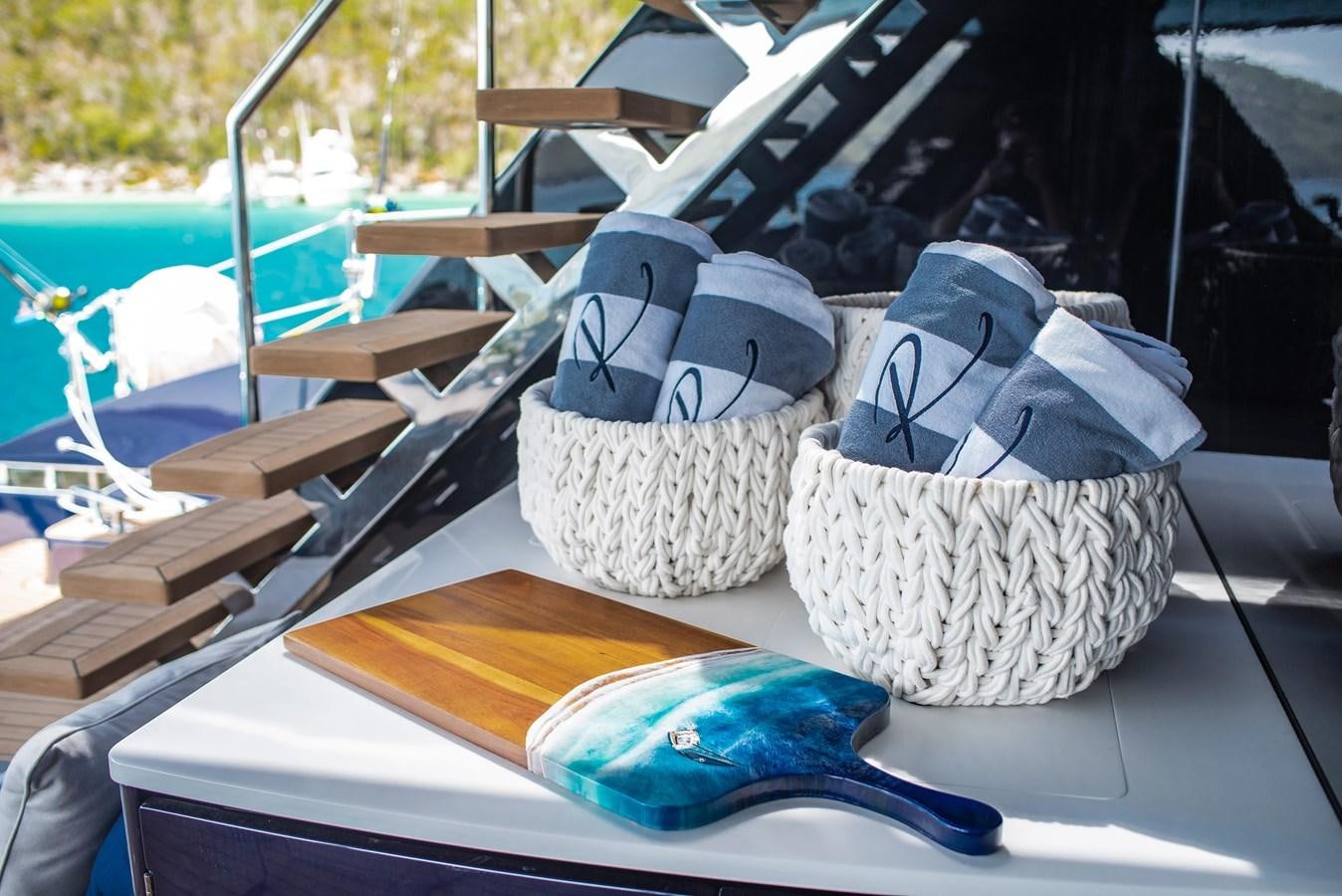 a pair of hats on a table aboard 2022 SUNREEF 80 SAILING Yacht for Sale