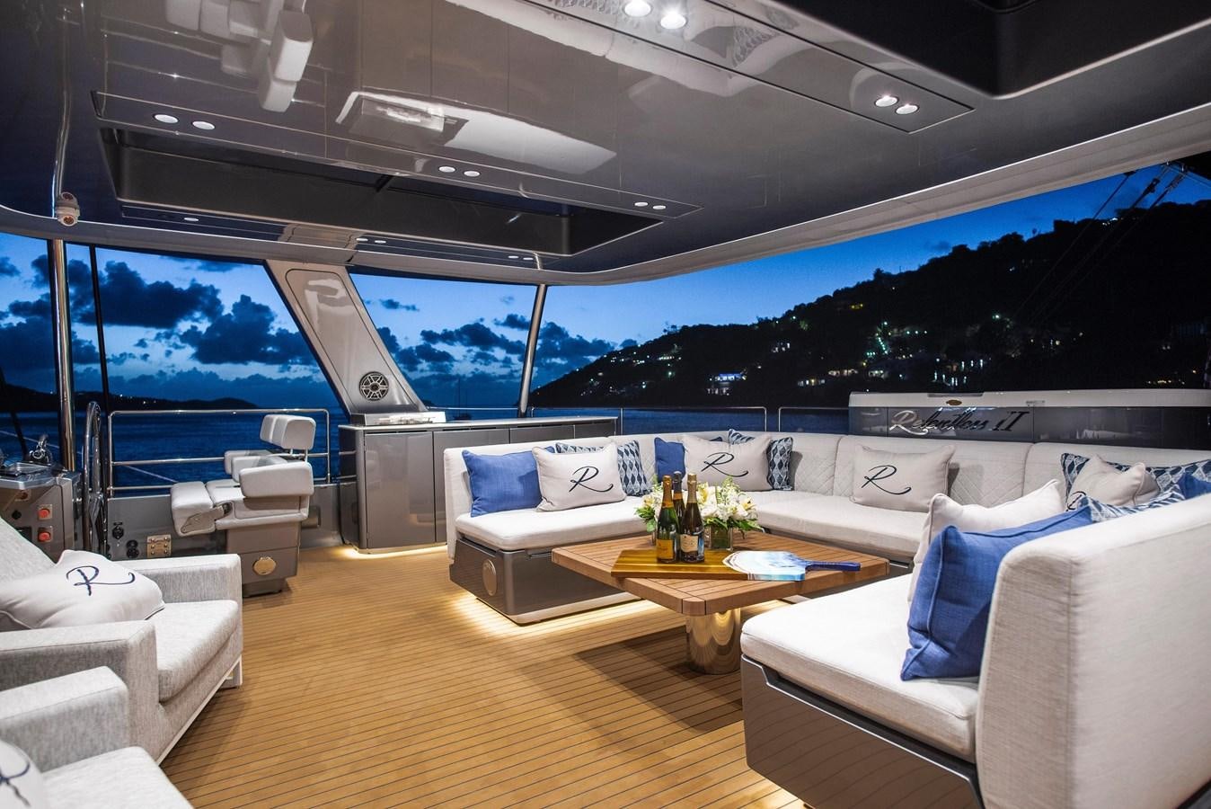 a living room with a large window aboard 2022 SUNREEF 80 SAILING Yacht for Sale