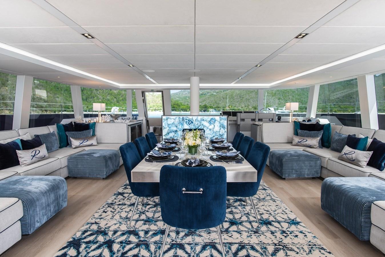 a large room with couches and a table aboard 2022 SUNREEF 80 SAILING Yacht for Sale