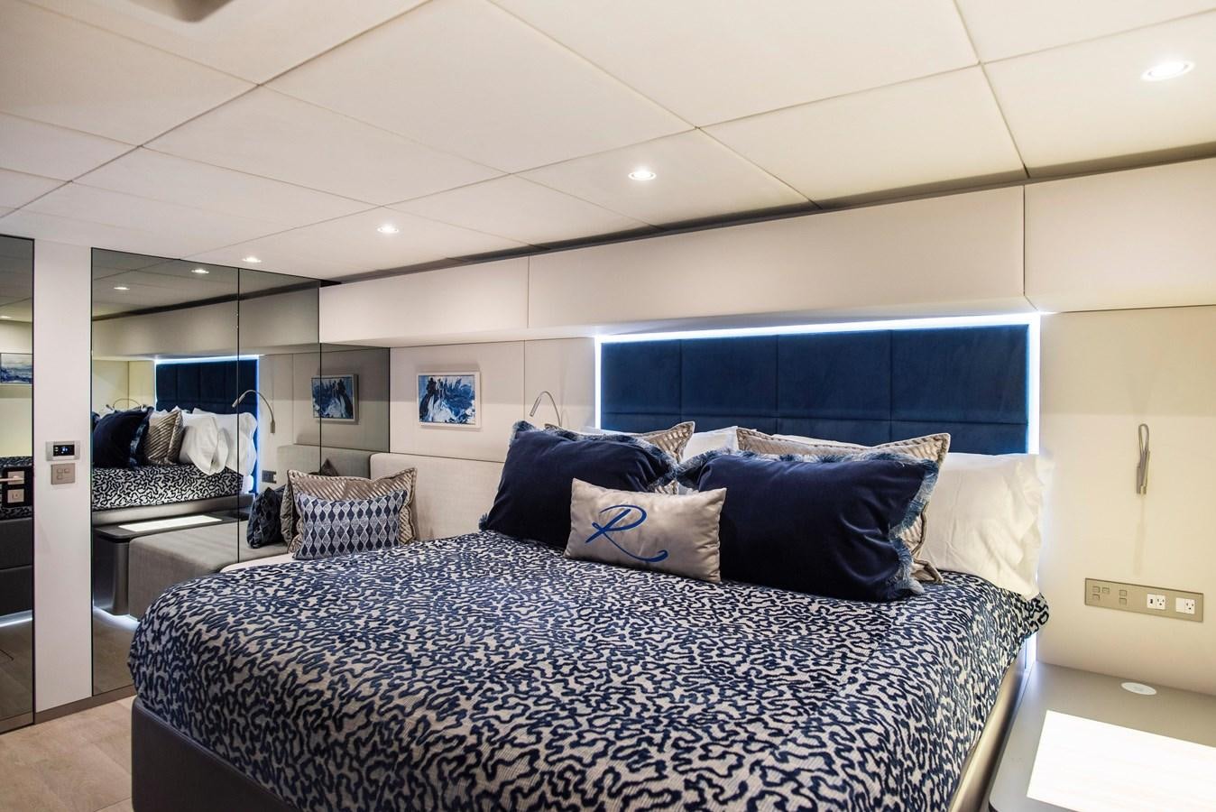 a bedroom with a bed and a blue and white bed aboard 2022 SUNREEF 80 SAILING Yacht for Sale
