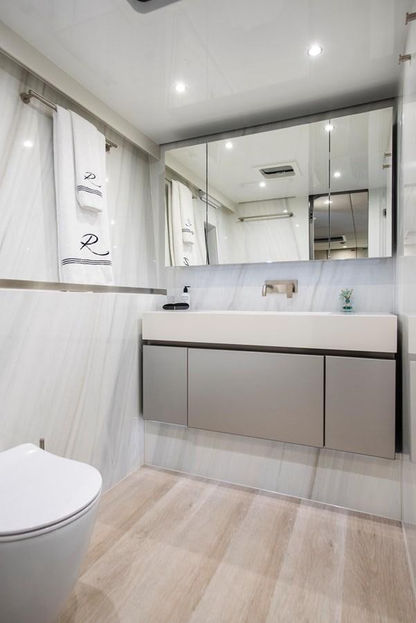 a bathroom with a large mirror aboard 2022 SUNREEF 80 SAILING Yacht for Sale