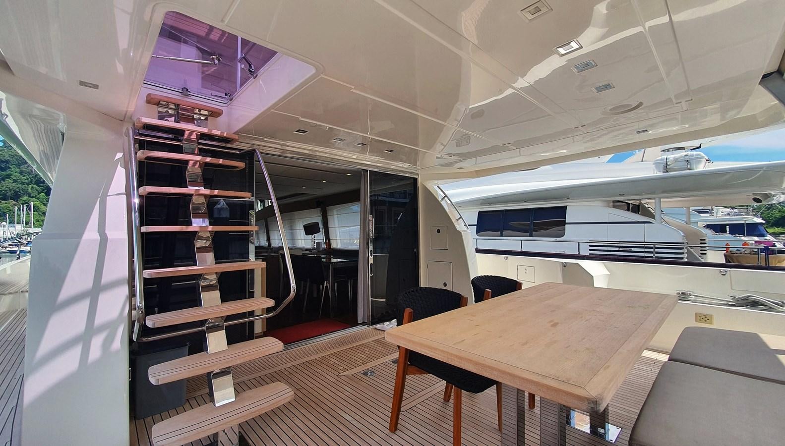 a room with a table and chairs aboard NEW FISH Yacht for Sale