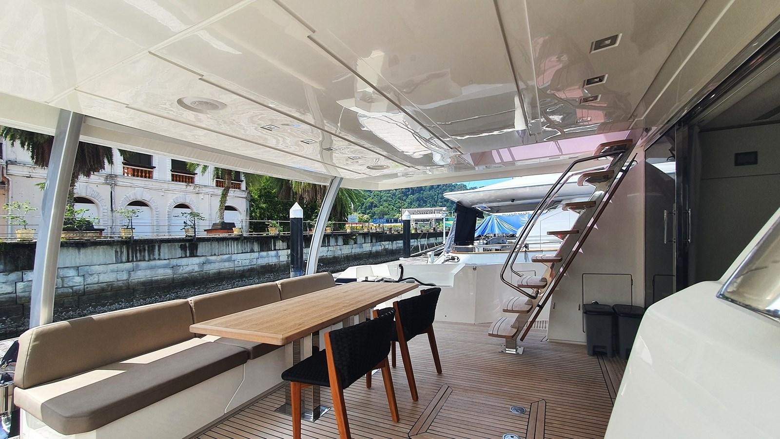 a room with a table and chairs aboard NEW FISH Yacht for Sale