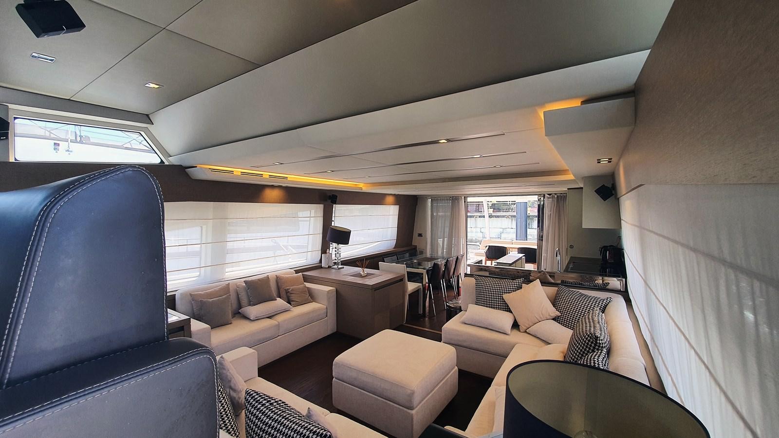 a room with a couch and a table and a television aboard NEW FISH Yacht for Sale
