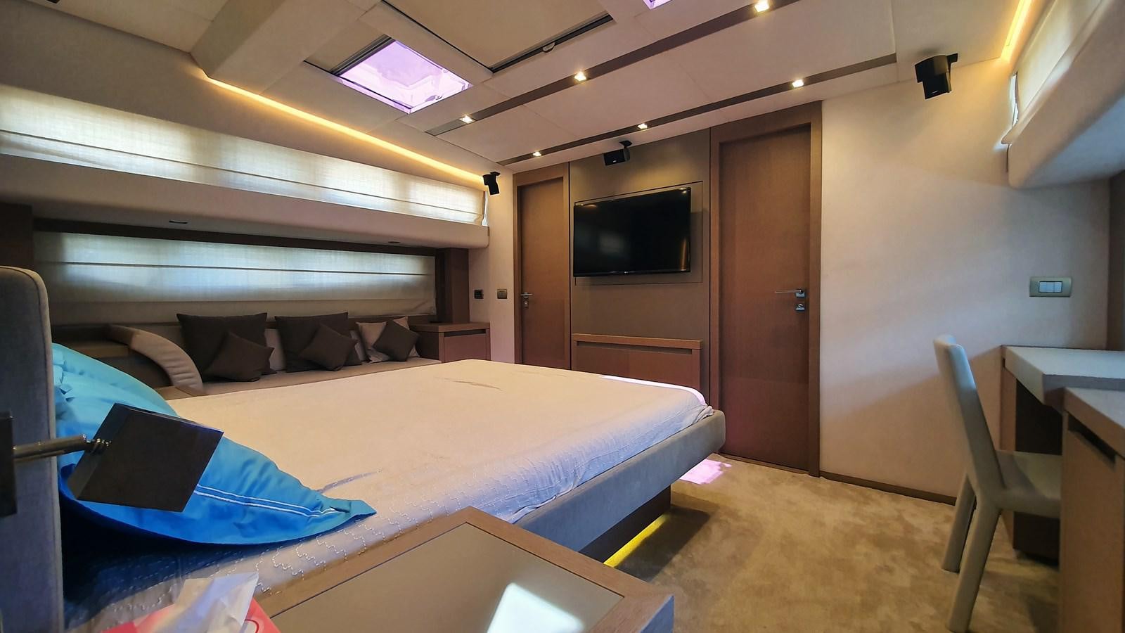 a room with a bed and a television aboard NEW FISH Yacht for Sale