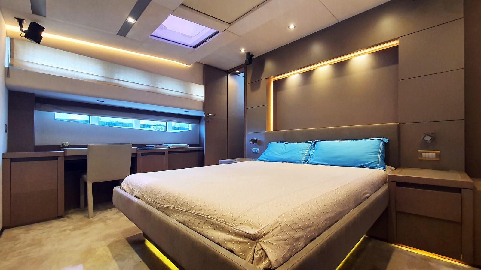 a room with a bed and desk aboard NEW FISH Yacht for Sale