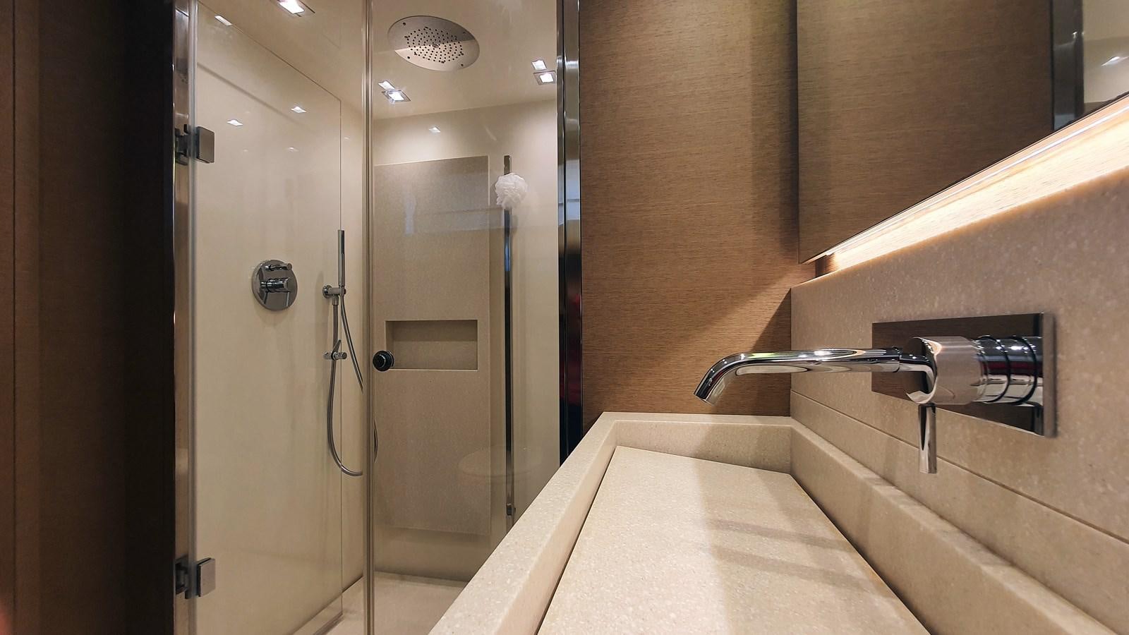 a bathroom with a bathtub and shower aboard NEW FISH Yacht for Sale