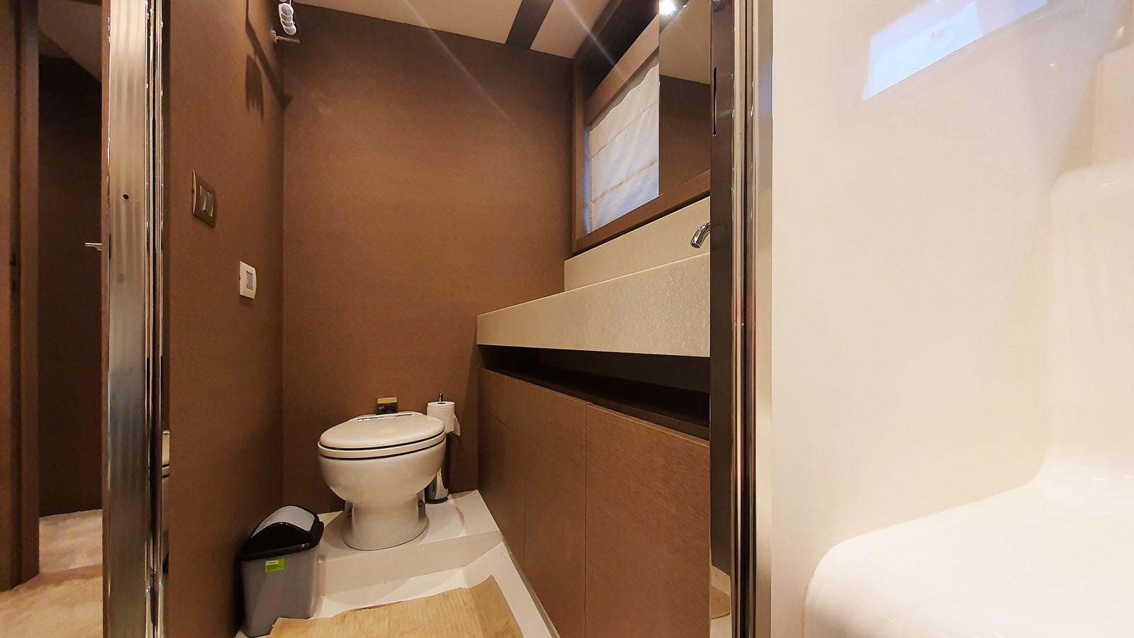 a bathroom with a toilet and a sink aboard NEW FISH Yacht for Sale