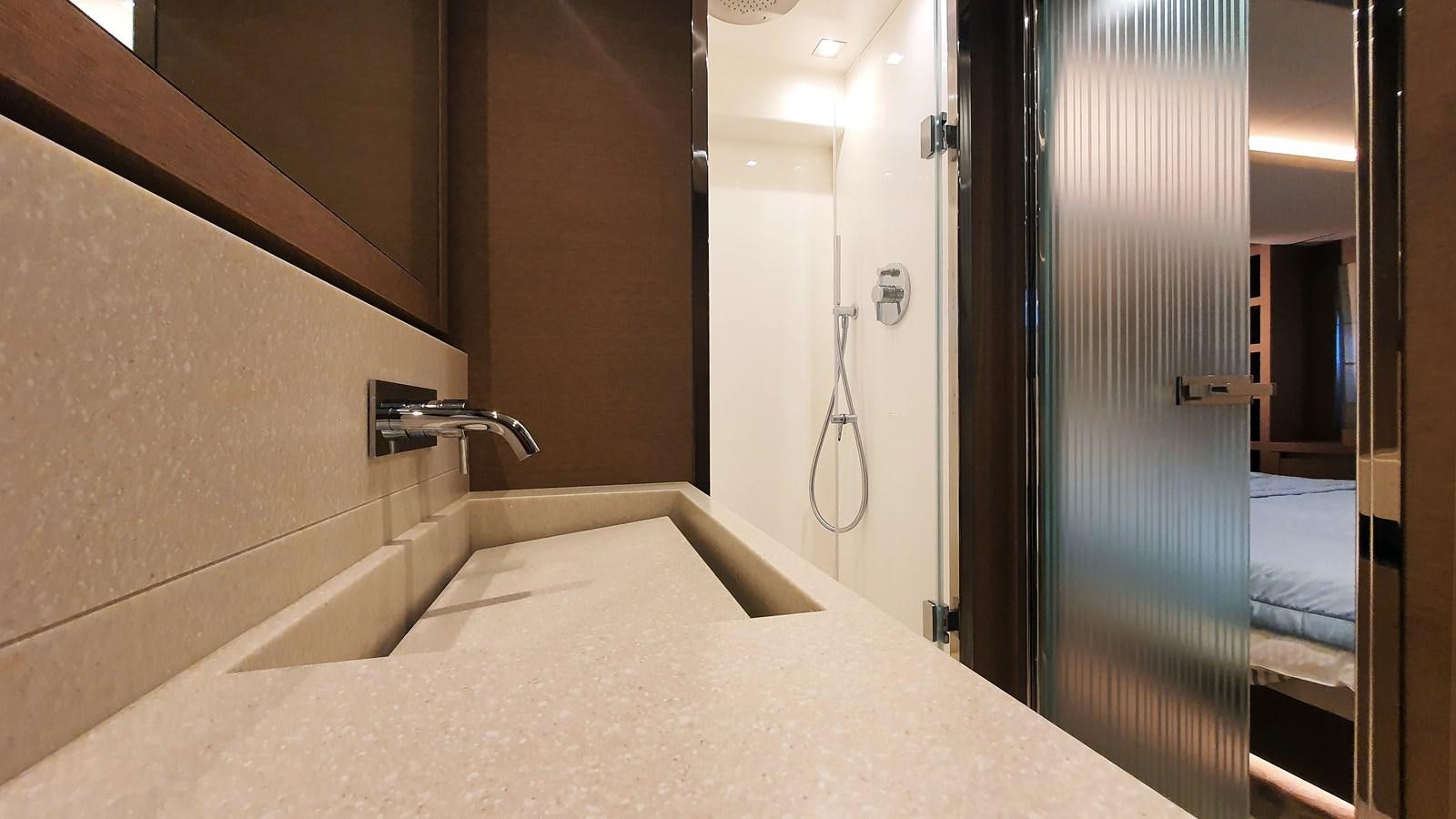 a bathroom with a bathtub and a sink aboard NEW FISH Yacht for Sale