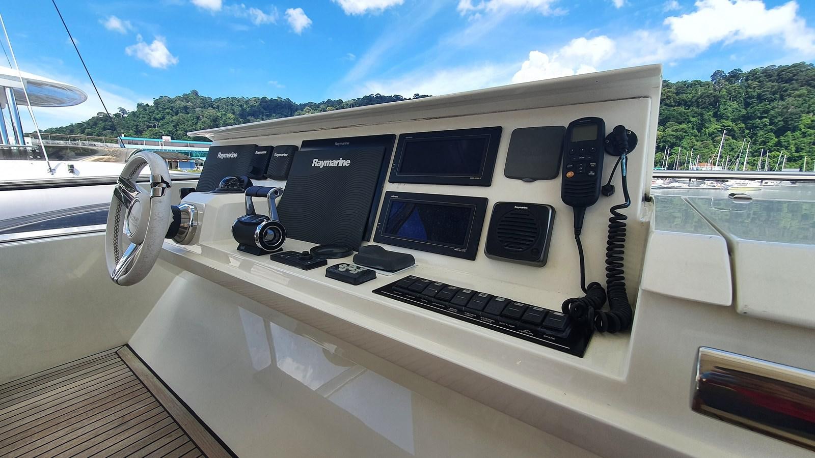 a white vehicle with a black keyboard and a phone on the front aboard NEW FISH Yacht for Sale