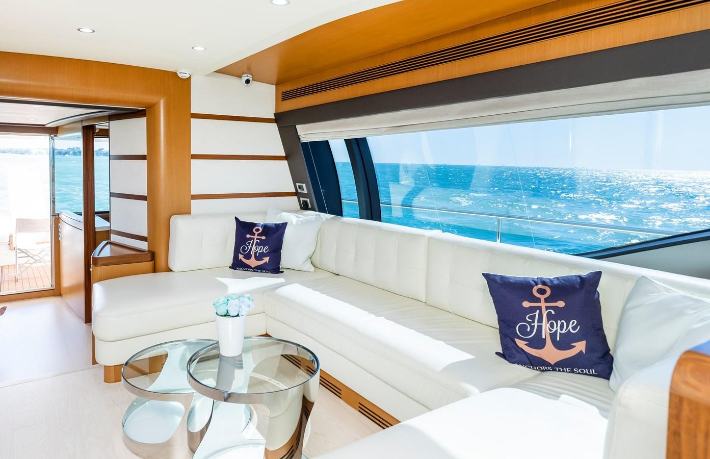 a white couch with blue pillows aboard HOPE Yacht for Sale