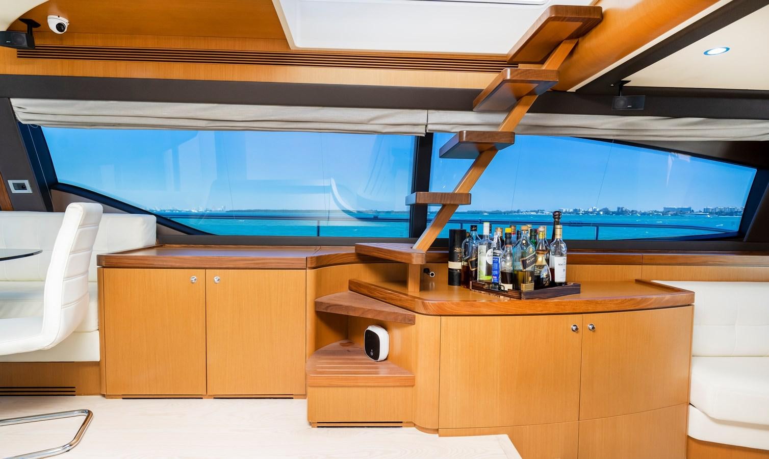 a bar with a bar and a shelf of bottles on it aboard HOPE Yacht for Sale
