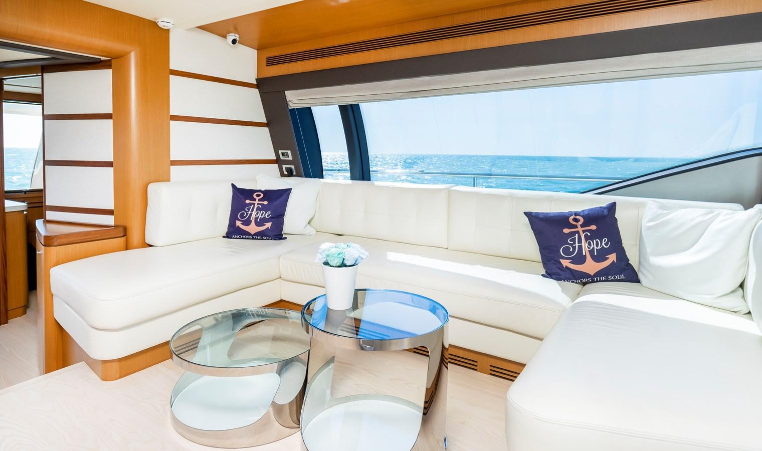 a white couch with blue pillows aboard HOPE Yacht for Sale