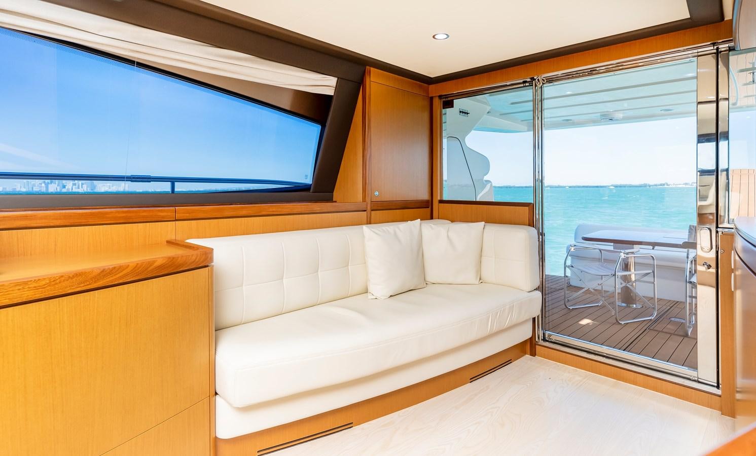 a room with a couch and a large window aboard HOPE Yacht for Sale