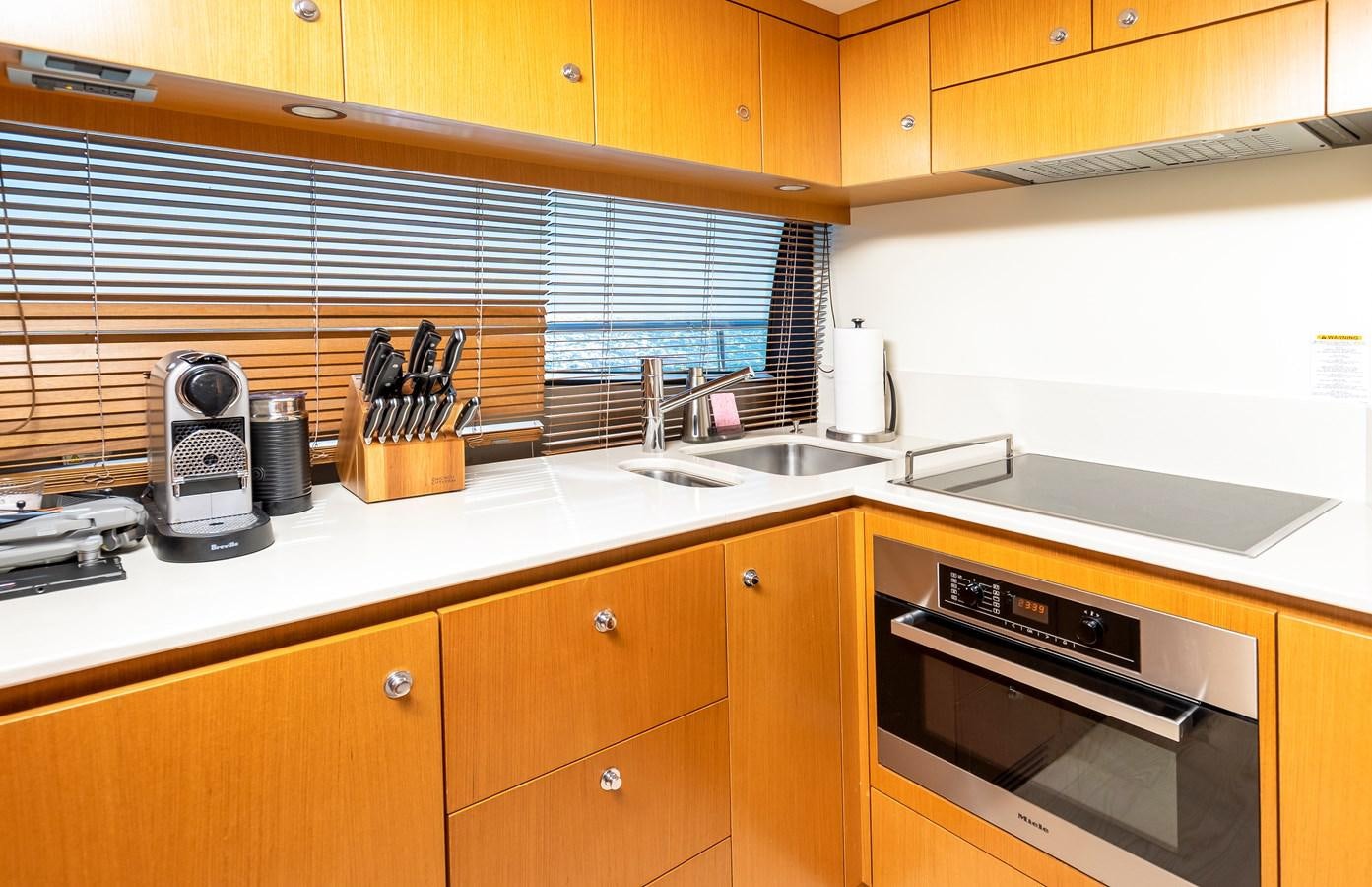 a kitchen with wooden cabinets aboard HOPE Yacht for Sale