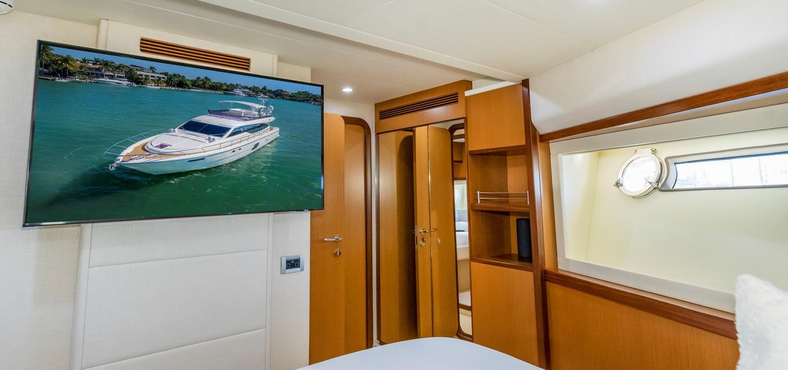 a room with a television and a table and a television aboard HOPE Yacht for Sale