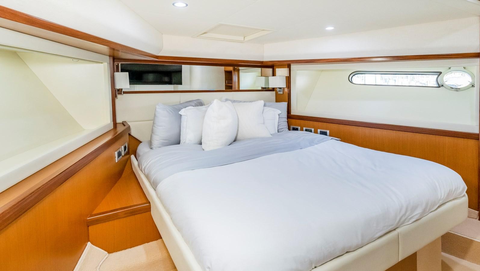 a room with a bed and a desk aboard HOPE Yacht for Sale
