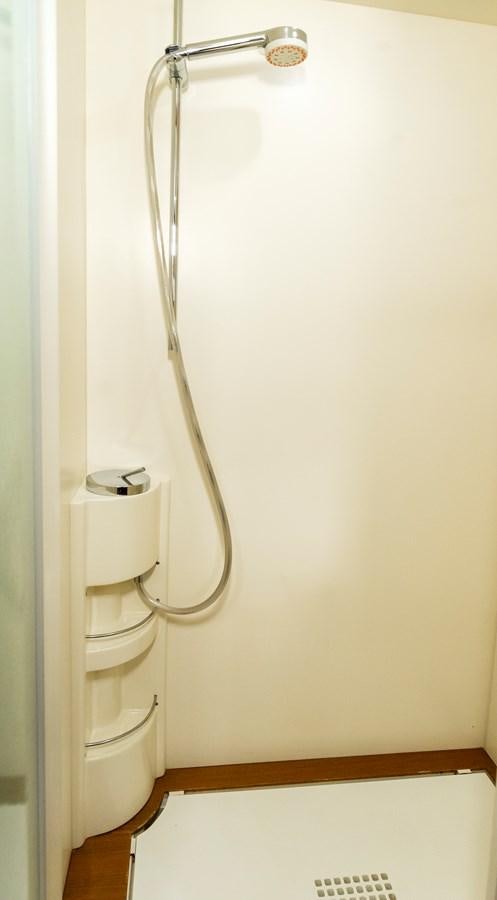 a shower head with a white wall aboard HOPE Yacht for Sale